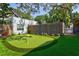 Backyard putting green with artificial turf, flags, and a surrounding fence for recreational enjoyment at 1523 1St W Ave, Bradenton, FL 34205
