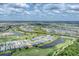 Expansive aerial view of a community featuring houses along a golf course and multiple ponds at 15813 San Lazzaro Ave, Bradenton, FL 34211