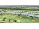 Aerial view of homes backing onto a lush golf course and serene ponds at 15813 San Lazzaro Ave, Bradenton, FL 34211
