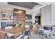 Social room boasts modern decor with wooden table, designer lighting, built-in wine storage, and seating for large gatherings at 15813 San Lazzaro Ave, Bradenton, FL 34211