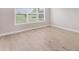 Bright bedroom with large window offering abundant natural light and light wood-look flooring at 15813 San Lazzaro Ave, Bradenton, FL 34211