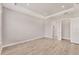 Spacious bedroom featuring tray ceilings, recessed lighting, and light wood-look flooring at 15813 San Lazzaro Ave, Bradenton, FL 34211