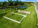 Well-manicured entrance to a community with green lawns, palm trees and stone sign at 15813 San Lazzaro Ave, Bradenton, FL 34211