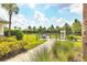 Fenced dog park area with grassy space and mature trees for shade at 15813 San Lazzaro Ave, Bradenton, FL 34211