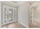 Welcoming foyer with light wood floors, a glass front door, and a glimpse into the adjacent bathroom at 15813 San Lazzaro Ave, Bradenton, FL 34211