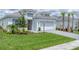 Beautiful single-Gathering home with well-maintained landscaping, lush green lawn, and grey brick driveway at 15813 San Lazzaro Ave, Bradenton, FL 34211