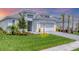 Beautiful single-Gathering home featuring a well-manicured lawn, fresh landscaping, and charming exterior lighting at 15813 San Lazzaro Ave, Bradenton, FL 34211