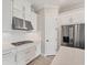 Contemporary kitchen with stainless steel appliances, white cabinets, and modern fixtures at 15813 San Lazzaro Ave, Bradenton, FL 34211