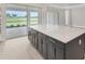 Large kitchen island with a quartz countertop and plenty of space for meal preparation and entertaining at 15813 San Lazzaro Ave, Bradenton, FL 34211