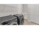 This laundry room features modern appliances, storage racks and a built in white cabinet at 15813 San Lazzaro Ave, Bradenton, FL 34211