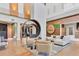 Inviting lobby featuring modern seating, wood floors, accent walls, and a circular metal sculpture, creating a stylish gathering space at 15813 San Lazzaro Ave, Bradenton, FL 34211
