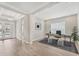 Stylish home office with modern desk, decorative lighting, and views of the front yard through the front door at 15813 San Lazzaro Ave, Bradenton, FL 34211