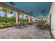 Covered outdoor dining area with several tables and chairs, perfect for enjoying the weather at 15813 San Lazzaro Ave, Bradenton, FL 34211