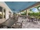 Inviting outdoor dining area with seating and a covered patio with ceiling fans at 15813 San Lazzaro Ave, Bradenton, FL 34211