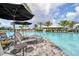 Resort-style pool with lounge chairs, umbrellas, and a nearby bar for relaxation and enjoyment at 15813 San Lazzaro Ave, Bradenton, FL 34211