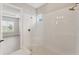 Modern shower with frameless glass enclosure and white subway tile surround at 15813 San Lazzaro Ave, Bradenton, FL 34211