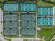 Aerial view of multiple tennis courts with vibrant green and blue surfaces at 15813 San Lazzaro Ave, Bradenton, FL 34211