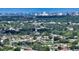 The aerial view captures this lovely single-Gathering home surrounded by lush greenery and a pond near the city at 1677 Fleetwood Dr, Sarasota, FL 34232