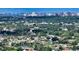 Aerial view showcases this lovely single-Gathering home near the city, lush greenery and peaceful pond at 1677 Fleetwood Dr, Sarasota, FL 34232