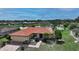 Charming single-Gathering home boasts a tile roof, attached garage, and landscaped front yard at 1677 Fleetwood Dr, Sarasota, FL 34232