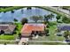 Beautiful single-Gathering home with a lovely pond view, a tile roof and lush landscaping at 1677 Fleetwood Dr, Sarasota, FL 34232