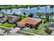 Single-Gathering home featuring a tile roof and well-manicured lawn in a tranquil neighborhood at 1677 Fleetwood Dr, Sarasota, FL 34232