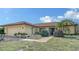 Well-kept single-Gathering home featuring an attached garage, tile roof, and charming landscaping at 1677 Fleetwood Dr, Sarasota, FL 34232