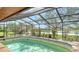 Enjoy the screened-in pool with a view of the outdoors and pond at 1677 Fleetwood Dr, Sarasota, FL 34232