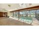 Enclosed pool area with ceiling fans and generous space for comfortable lounge chairs. Pool offers scenic lake views at 1677 Fleetwood Dr, Sarasota, FL 34232
