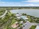 Aerial view of community clubhouse, playground, parking, and lake with lush landscaping at 17204 Bullhorn Cir, Punta Gorda, FL 33982