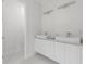 Clean and modern bathroom with double vanities, vessel sinks, and a neutral color palette at 17204 Bullhorn Cir, Punta Gorda, FL 33982