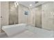 Luxurious bathroom featuring a freestanding tub, glass-enclosed shower, and elegant tile work at 17204 Bullhorn Cir, Punta Gorda, FL 33982