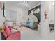 Unique bedroom featuring a princess carriage bed and a cozy pink armchair at 17204 Bullhorn Cir, Punta Gorda, FL 33982