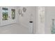 Bright foyer with tile flooring leads to a bathroom and showcases modern decor at 17204 Bullhorn Cir, Punta Gorda, FL 33982