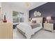 Elegant bedroom with decorative wall and modern lighting, complete with a large window at 17204 Bullhorn Cir, Punta Gorda, FL 33982