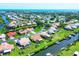 An aerial view of a waterfront community, lush landscaping, and neighborhood boat docks along the waterway at 175 Inlets Blvd # 175, Nokomis, FL 34275