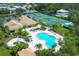 Aerial shot of community pool and spa, tennis courts, clubhouse, and meticulously landscaped grounds at 175 Inlets Blvd # 175, Nokomis, FL 34275