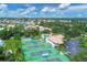Beautiful aerial view of community with tennis courts, swimming pool, clubhouse, and lush landscaping at 175 Inlets Blvd # 175, Nokomis, FL 34275