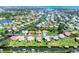 Stunning aerial view of a waterfront community with lush landscaping and canal access to open water at 175 Inlets Blvd # 175, Nokomis, FL 34275