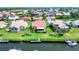 Aerial view of home with lush backyard, private dock, and waterway access in an established neighborhood at 175 Inlets Blvd # 175, Nokomis, FL 34275