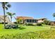 The backyard boasts green grass and a screen enclosed patio, with mature palms for added privacy at 175 Inlets Blvd # 175, Nokomis, FL 34275
