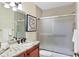 Bathroom featuring granite countertops, wooden cabinets, and a shower-tub combination at 175 Inlets Blvd # 175, Nokomis, FL 34275