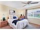 Bright bedroom with ceiling fan, bedside tables, and large window offering a view of the outdoors at 175 Inlets Blvd # 175, Nokomis, FL 34275