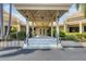 The clubhouse entrance showcases a covered entryway, glass doors, and manicured landscaping at 175 Inlets Blvd # 175, Nokomis, FL 34275