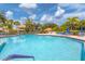 Sparkling community pool surrounded by lush landscaping and lounge chairs, perfect for relaxation at 175 Inlets Blvd # 175, Nokomis, FL 34275
