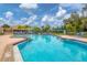 Large community pool with inviting blue water, surrounded by lounge chairs, offering a resort-style experience at 175 Inlets Blvd # 175, Nokomis, FL 34275