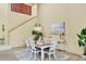 Bright dining room with modern chandelier, staircase access, and stylish decor at 175 Inlets Blvd # 175, Nokomis, FL 34275