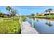 Waterfront home featuring private dock with lush landscaping and community waterway access on a clear day at 175 Inlets Blvd # 175, Nokomis, FL 34275