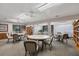 Bright game room featuring tables, chairs, and bookshelves with large windows, great for community socializing at 175 Inlets Blvd # 175, Nokomis, FL 34275