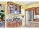 The kitchen features a stainless steel fridge, granite countertops, and wooden cabinets at 175 Inlets Blvd # 175, Nokomis, FL 34275
